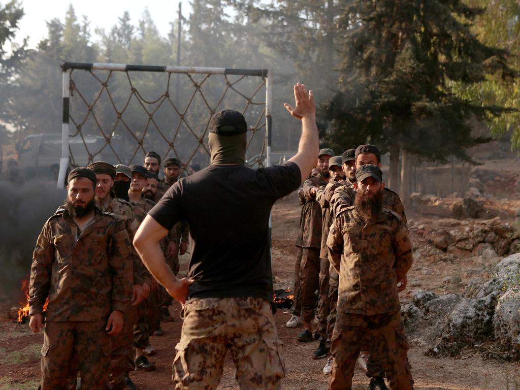 Members of the Hayat Tahrir al-Sham jihadist group attend a graduation for a new batch of fighters last month in Syria. Picture: Aaref Watad / AFP