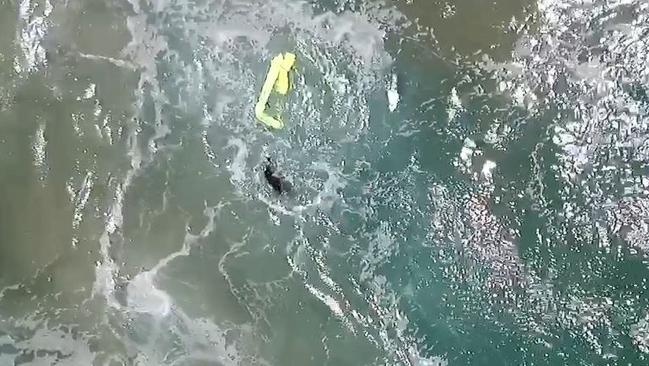 The device inflated when it hit the water allowing the surfers to hold on get into shore.