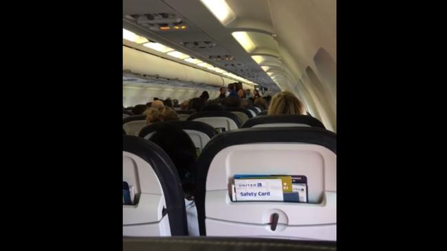 A United Airlines passenger has captured the extraordinary tirade by a pilot after passengers erupted in a politically-charged fight on board a flight from the US to Mexico. Picture: YouTube/Jon Bauer