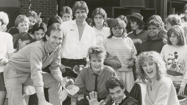 Greg Clarke, Mark Pedler and Di “Disey” Stapleton with stars from TV’s Neighbours and fans in the 1980s. Picture: Advertiser Library