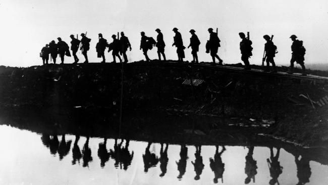 Long slog to peace; and after that, to recovery … soldiers of the 1st Australian Division on a duckboard track on the Western Front, near Hooge, Belgium, in October 1917. Picture by James ‘Frank’ Hurley.