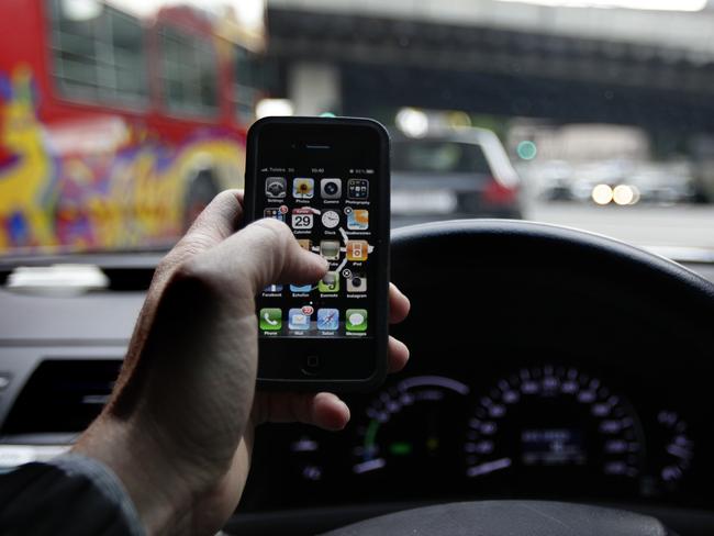 LEGAL WARNING: No warning details supplied...NO BYLINE... 29/05/2011 NEWS: Generic photo of a motorist texting and using other iPhone apps while driving a car in Sydney. Mobile phone Pic. Brad Hunter