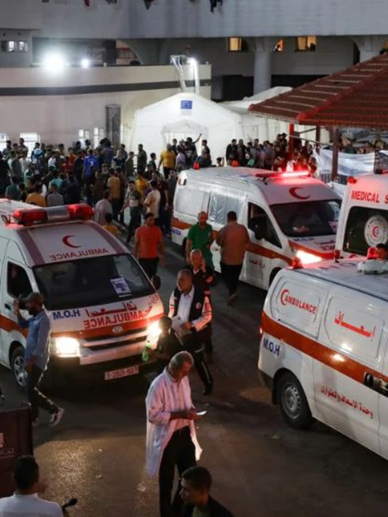 Ambulances carrying victims of Israeli strikes crowd the entrance to the emergency ward of Al-Shifa Hospital. Dawood Nemer/AFP/Getty Images