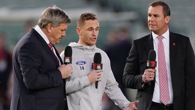 Joel Selwood of the Cats speaks to television commentators Brian Taylor and Wayne Carey, who has been shuffled to Saturday nights.