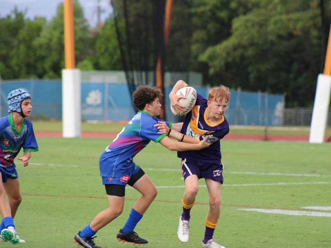 Edmonton Storm five-eight Bailey Sheahan busts through a tackle during the Far North Queensland Under 13s grand final at Barlow Park against Innisfail Leprechauns. Picture: Jake Garland