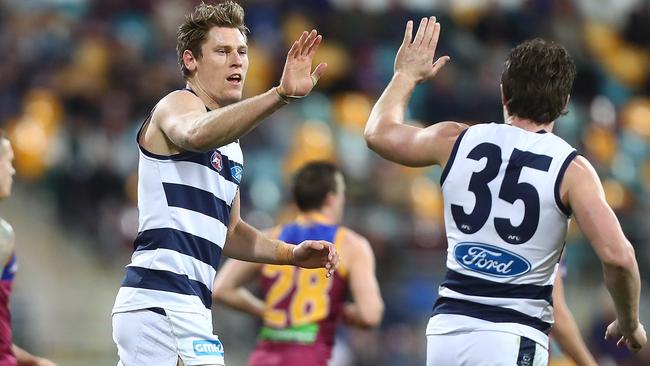 Mark Blicavs celebrates one of his three goals against the Lions last night with superstar Patrick Dangerfield. Picture: Getty Images