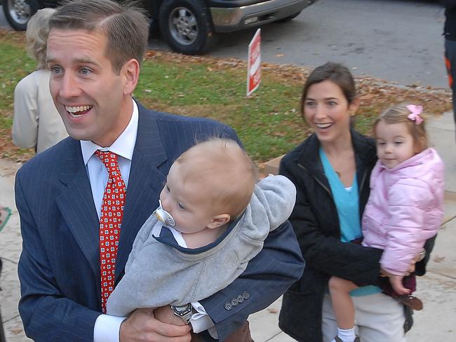 Family man ... Beau Biden, holds his son, Hunter, as he walks with his wife, Hallie, holding their daughter, Natalie in 2006 as they enter a polling place. Picture: AP/Pat Crowe II