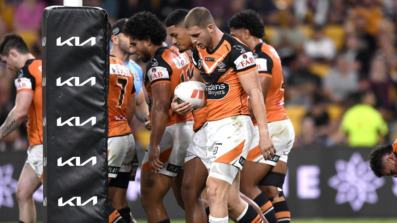 Wests Tigers players show their frustration after a Broncos try.