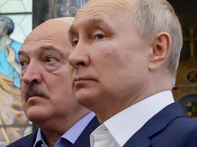 Russia's President Vladimir Putin (R) and Belarus' President Alexander Lukashenko (L) visit The Naval Cathedral of Saint Nicholas in Kronstadt, on Kotlin Island, outside Saint Petersburg, on July 23, 2023. Putin and his Belarus counterpart met a crowd of people in Kronstadt, in a rare walkabout for the longtime leaders a month after a deal to end a dramatic Wagner munity in Russia. (Photo by Alexandr Demyanchuk / SPUTNIK / AFP)