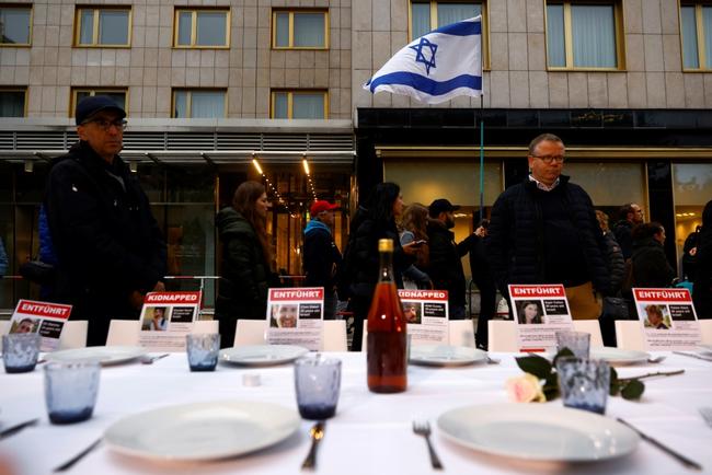 A person waves an Israeli flag at an event in Germany in solidarity with hostages taken in the Hamas attack