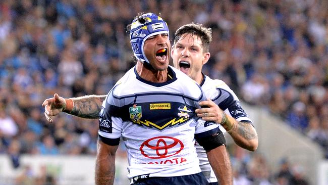 Johnathan Thurston of the Cowboys celebrates a try by teammate Gavin Cooper during the Round 25 NRL match between the Gold Coast Titans and the North Queensland Cowboys at Cbus Super Stadium. Photo: Getty Images