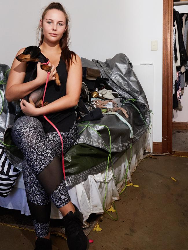 Lauren Schiller in her bedroom after the flood damaged carpet was removed. Picture: MATT LOXTON