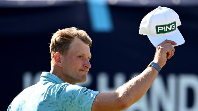 Poland's Adrian Meronk acknowledges the applause after finishing his third round (Photo by William WEST / AFP) / -