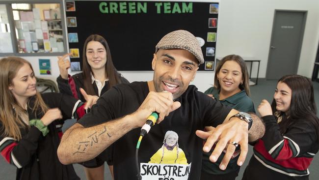 Doncaster Secondary College teacher Ty Dennis has covered a Jay-Z hit to draw attention to climate change. He’s joined by students Jorja, Jade, Jacqueline and Carol. Picture: Ellen Smith.