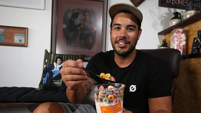 Randy Wallhole owner Ty Kudla digs into a cup of Fruit Loops. Photo: Regi Varghese