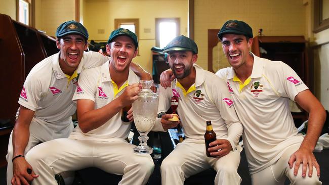 Australia's bowlers Mitchell Starc, Josh Hazlewood, Nathan Lyon and Pat Cummins who all took over 20 wickets each in the series celebrate with the urn in the dressing rooms of the SCG after winning the The Ashes. Picture. Phil Hillyard