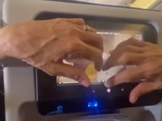 This plane passenger was touching the screen behind them on a long haul flight. Picture: Reddit