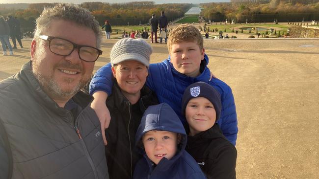 Philip and Amanda Burgess with sons Luka, Oliver and Tom at Versailles in France on their around-the-world trip.