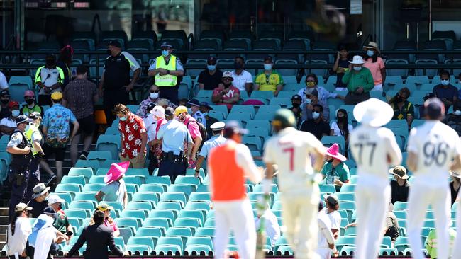 Indian players watch on as spectators are asked to leave their seats. Picture: Getty Images