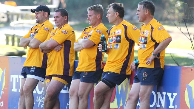 Past Broncos players including Chris Johns, far right, watch a training session