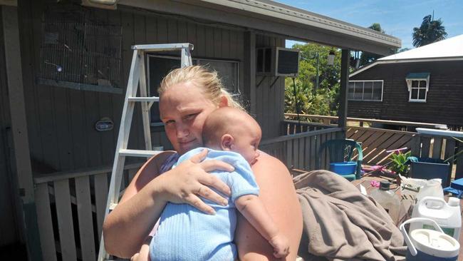 TWO WEEKS LATER: North Bundaberg resident Amber Masefield will never forget the harrowing experience of scrambling up a ladder onto the roof of her highset home with her infant son Harlem to escape the fury of the flood. Photo: Max Fleet / NewsMail. Picture: Max Fleet BUN120213NOR5