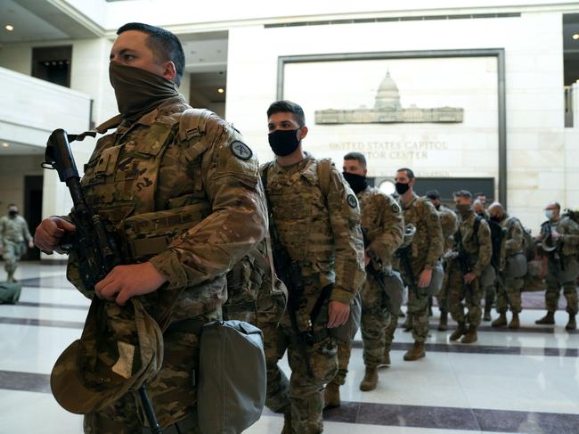 Members of the National Guard walk through the Visitor Center of the US Capitol. Picture: AFP