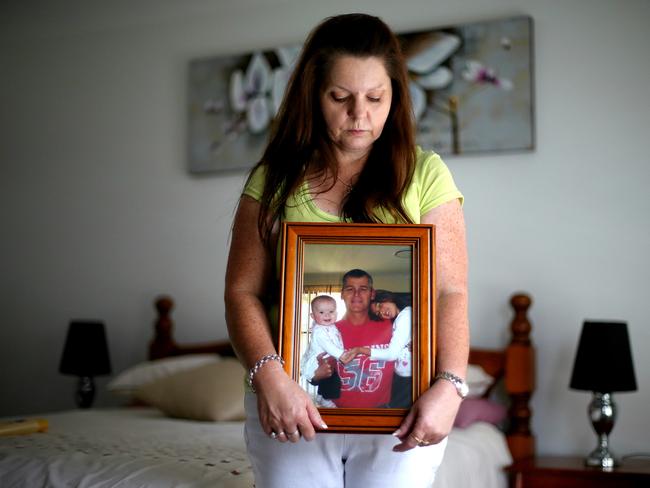 Sharon Tozer with a picture of her husband Mick and two daughters Ella and Tamia / Picture: Adam Taylor