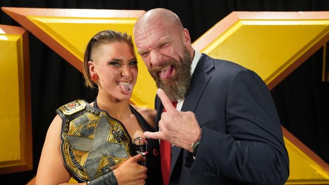 Adelaide-born wrestler Rhea Ripley, celebrating her NXT Women's Championship win with WWE boss Triple H. Picture: WWE