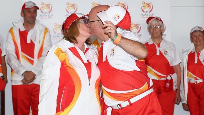 Volunteers Maureen Robinson and Les Robinson share a kiss as they walk the cat walk.