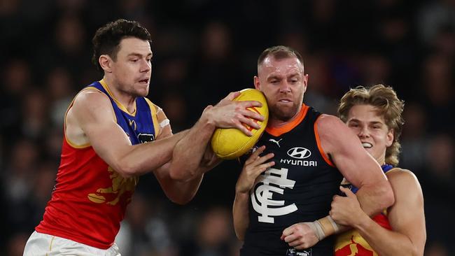 MELBOURNE. 05/05/2023. AFl.  Round 8. Carlton vs Brisbane Lions at Marvel Stadium. Sam Docherty of the Blues tackled by Lachie Neale and Will Ashcroft of the Lions  . Pic: Michael Klein