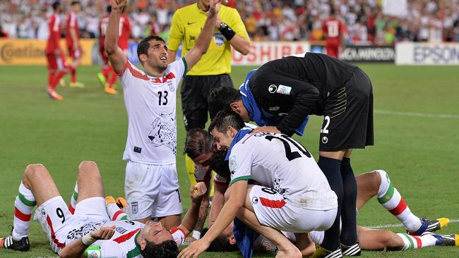 BRISBANE, AUSTRALIA - JANUARY 19: Reza Ghoochannejhad (L) of Iran is congratulated by team mates after scoring a goal during the 2015 Asian Cup match between IR Iran and the UAE at Suncorp Stadium on January 19, 2015 in Brisbane, Australia. (Photo by Bradley Kanaris/Getty Images)