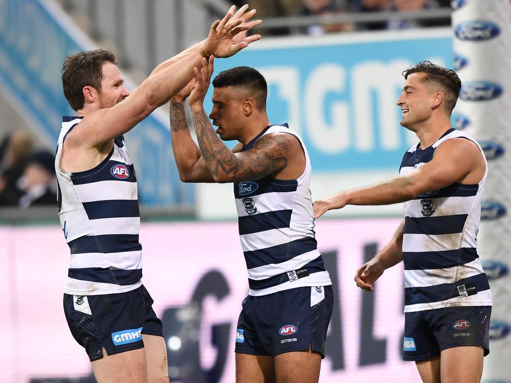 Tim Kelly of the Cats (centre) reacts after kicking a goal against the Crows. Picture: AAP Image/Julian Smith