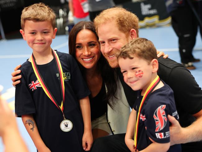 Harry and Meghan posing with kids at the Invictus Games. Picture: Chris Jackson/Getty Images