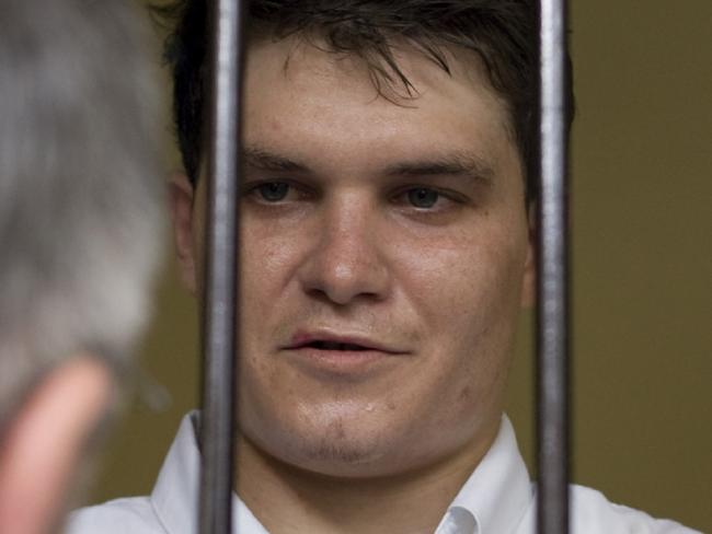 26/08/2010 WIRE: Australian drug mule Scott Rush, center, talks to Australian Government official from behind the bars at the Denpasar District Court before his final appeal hearing against his death sentence in Bali, Indonesia Thursday, Aug. 26, 2010. Rush, one of nine Australians found guilty in April 2005 of attempting to smuggle 8.3 kilograms (18.3 pounds) of heroin into Australia from the resort island of Bali, attended his final appeal hearing against his death sentence. (AP Photo/Firdia Lisnawati)