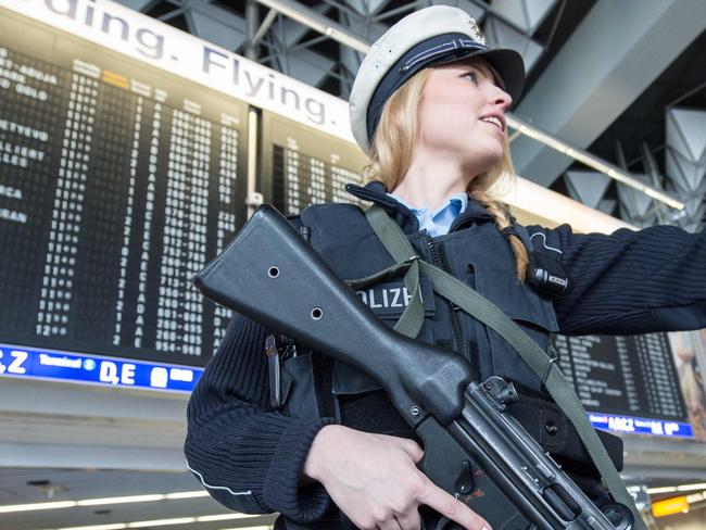 A armed policewoman gestures in Frankfurt Airport, on March 22, 2016, in Frankfurt, western Germany. The increased security comes in the wake of the explosions in Brussels, according to several media have claimed more lives. / AFP PHOTO / Scanpix Denmark / Boris Roessler / Germany OUT