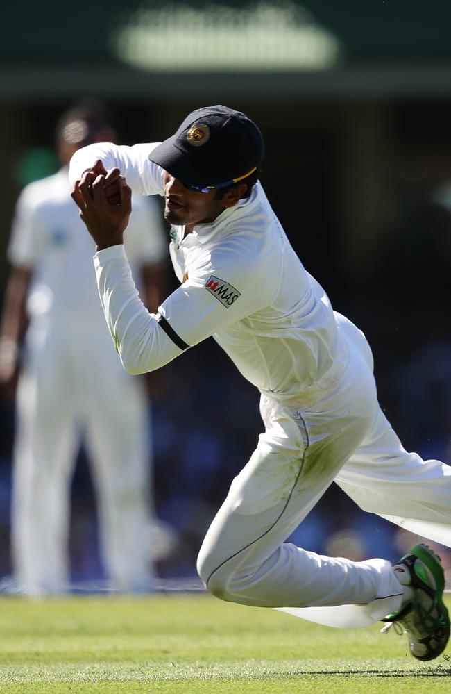 Dimuth Karunaratne takes a catch off the bowling of Rangana Herath.