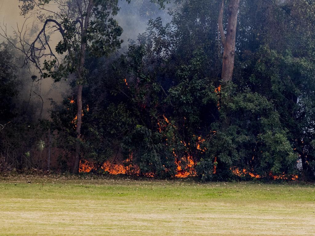 Smoke haze covers the Gold Coast Skyline from a grass fire at Carrara. Emergency services at St Michael's Collage, Merrimac. Fire burning near the school oval. Picture: Jerad Williams