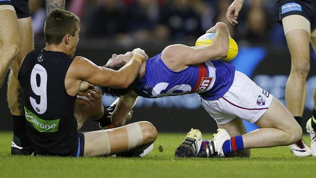 Toby McLean gets tackled high by Patrick Cripps. Picture: Michael Klein