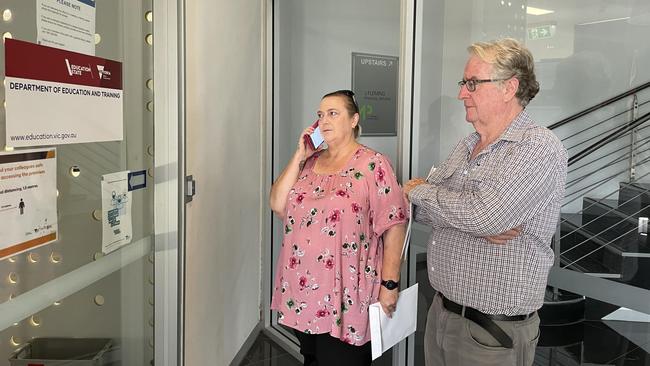 Jenny Bunion and Chris Gregory, parents at Devenish Primary School, wait for the education department to open their door.