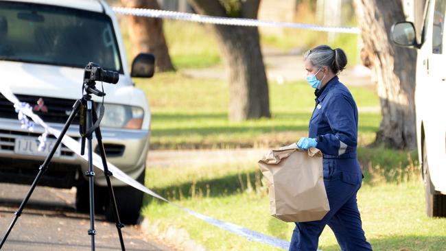 Forensic police remove evidence from the property this morning. Picture: Andrew Henshaw