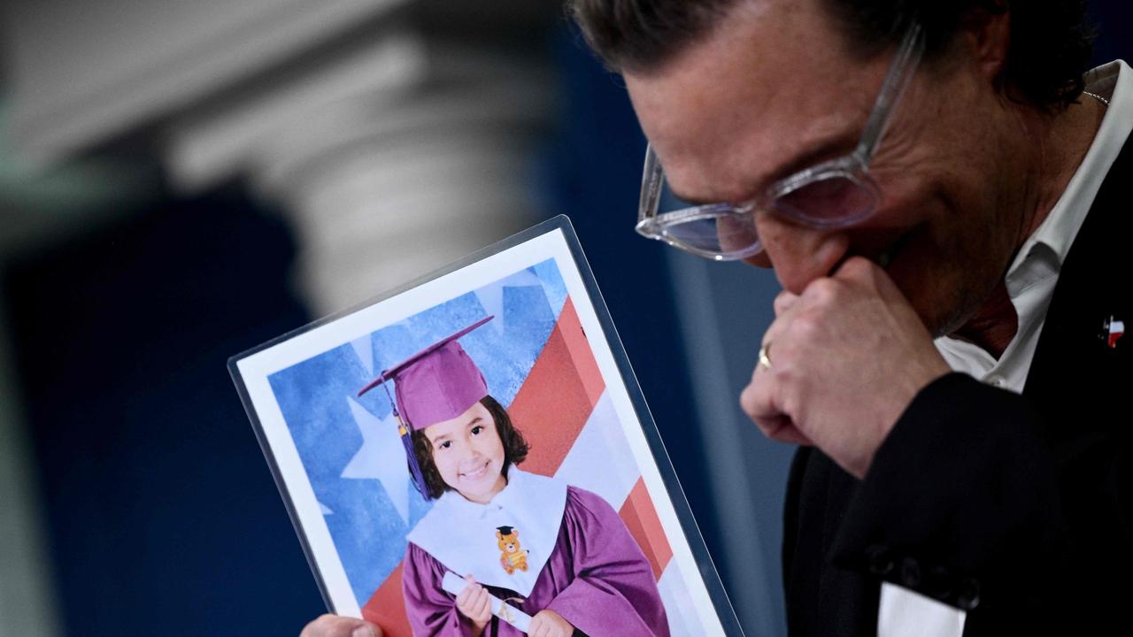 The actor appeared overcome with emotion as he held up pictures of shooting victims. Picture: AFP