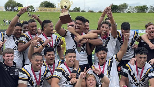 Happy days for Souths Logan captain Ahmani Leilua, with cup, and team mates.