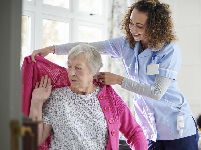 AGED CARE/NURSING HOME/SENIOR/RESIDENTIAL CARE. Picture: istock   home carer helping senior woman get dressed in her bedroom