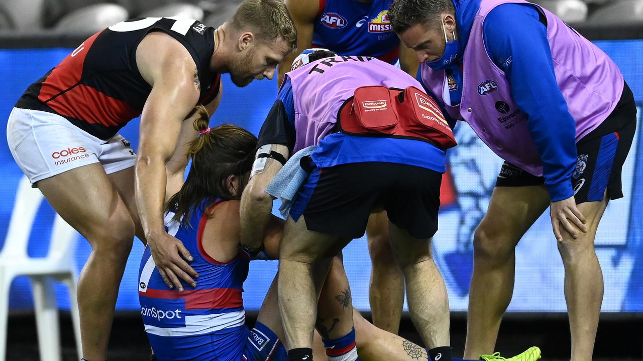 Essendon’s Jake Stringer helps Josh Bruce but, sadly for the big Bulldog, his season is over.