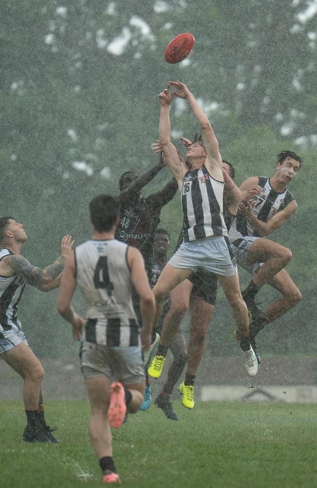 Palmerston Magpies and Tiwi Bombers players contesting the restart during Round 9 of the NTFL. Picture: Jack Riddiford / AFLNT Media