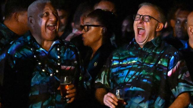 Australian Prime Minister Anthony Albanese (right reacts while interacting with Fiji's Prime Minister Frank Bainimarama (left) during the Beating of the Retreat ceremony at the Pacific Islands Forum (PIF) in Suva yesterday. Picture: AFP