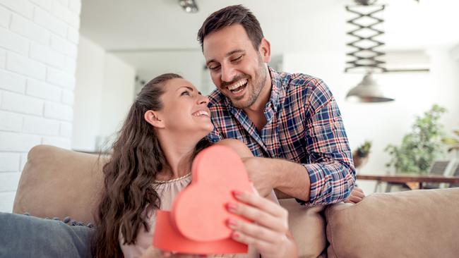 Young woman is happy and surprised with a gift from her husband.