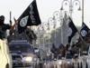 Militant Islamist fighters parade on military vehicles along the streets of northern Raqqa province