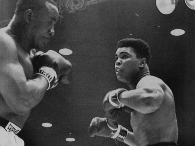 (L-R) Sonny Liston takes on Cassius Clay (later Muhammad Ali) in the world heavyweight title fight in Miami in 1964.