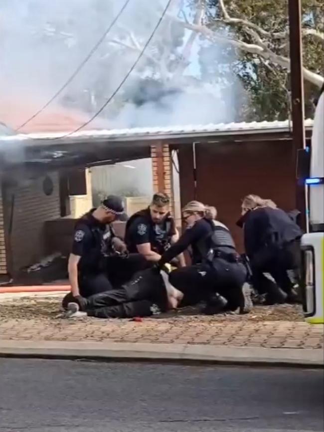 SAPOL said a female occupant was being detained at the scene of the fire when she allegedly assaulted a female police officer. Picture: 7NEWS